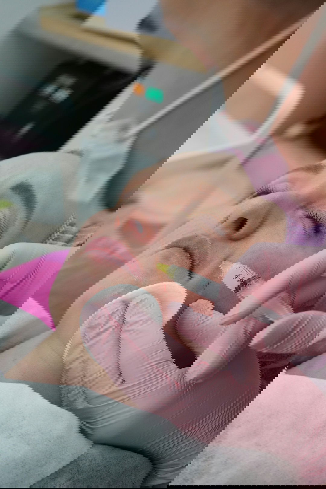 A woman getting her teeth checked by a dentist
